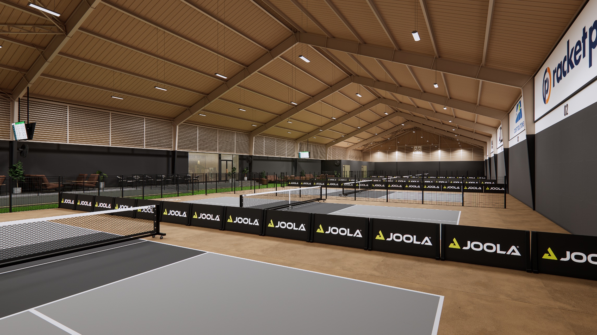TheCommune indoor pickleball courts under timber-pitched roof, JOOLA branded barriers.